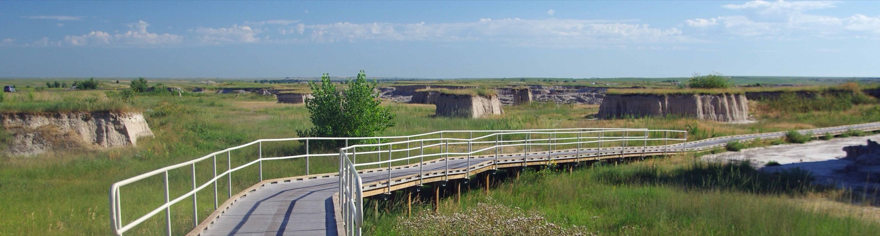 Door Trail boardwalk with railings running through the striped Badlands formations