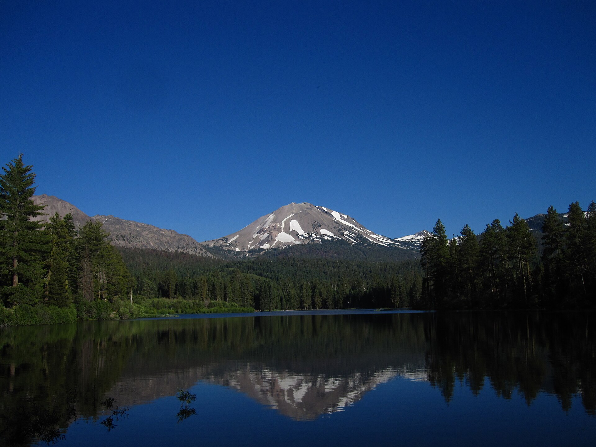 Lassen Peak reflected in the still water of Manzanita Lake in Lassen Volcanic National Park, California